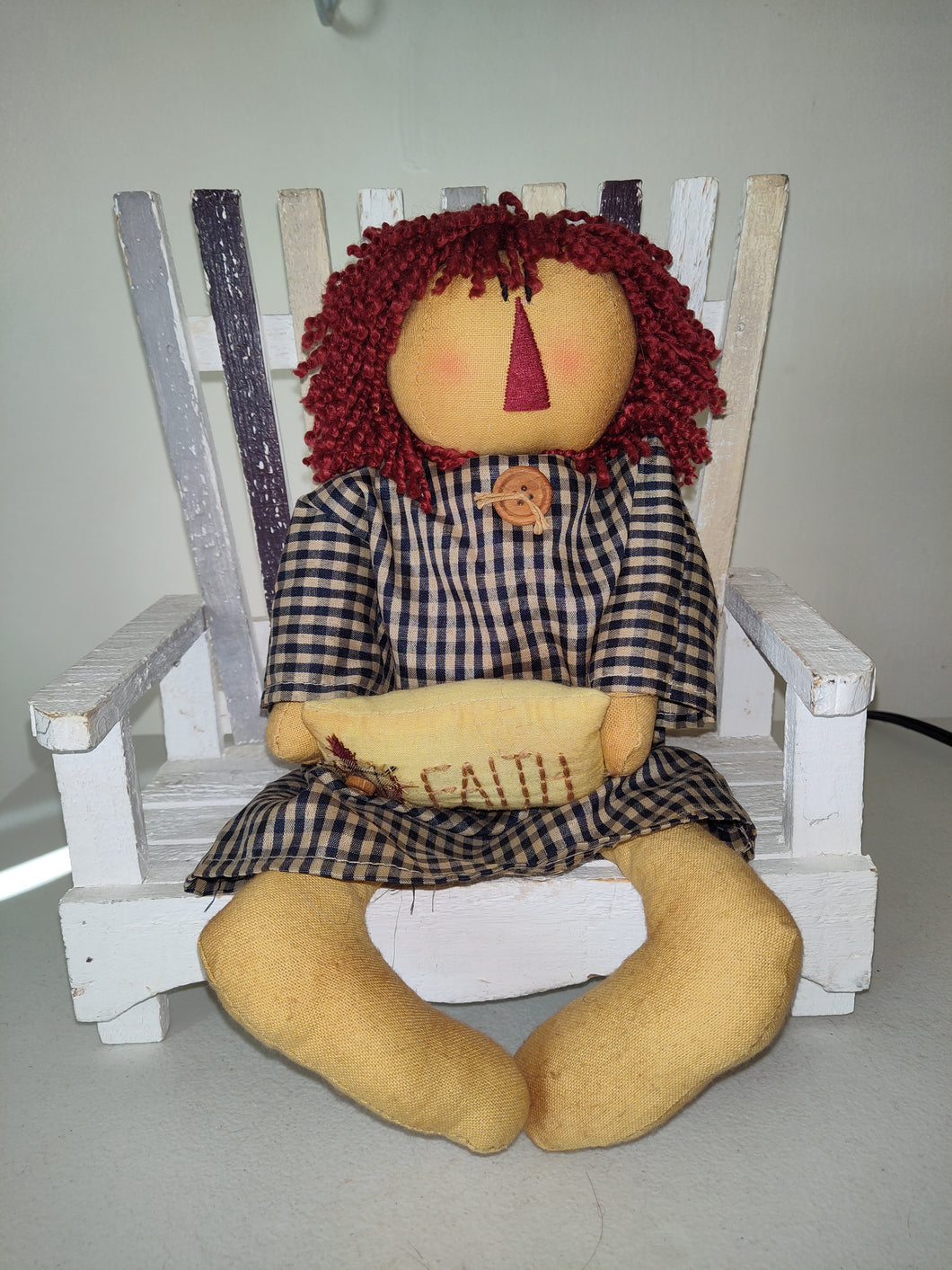 Primitive Doll Sitting On Bench