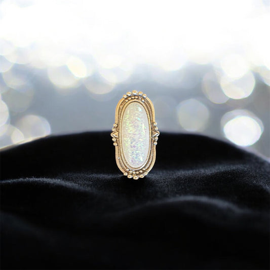 Anillo de ópalo sintético en tono plateado. Talla 7 ajustable.